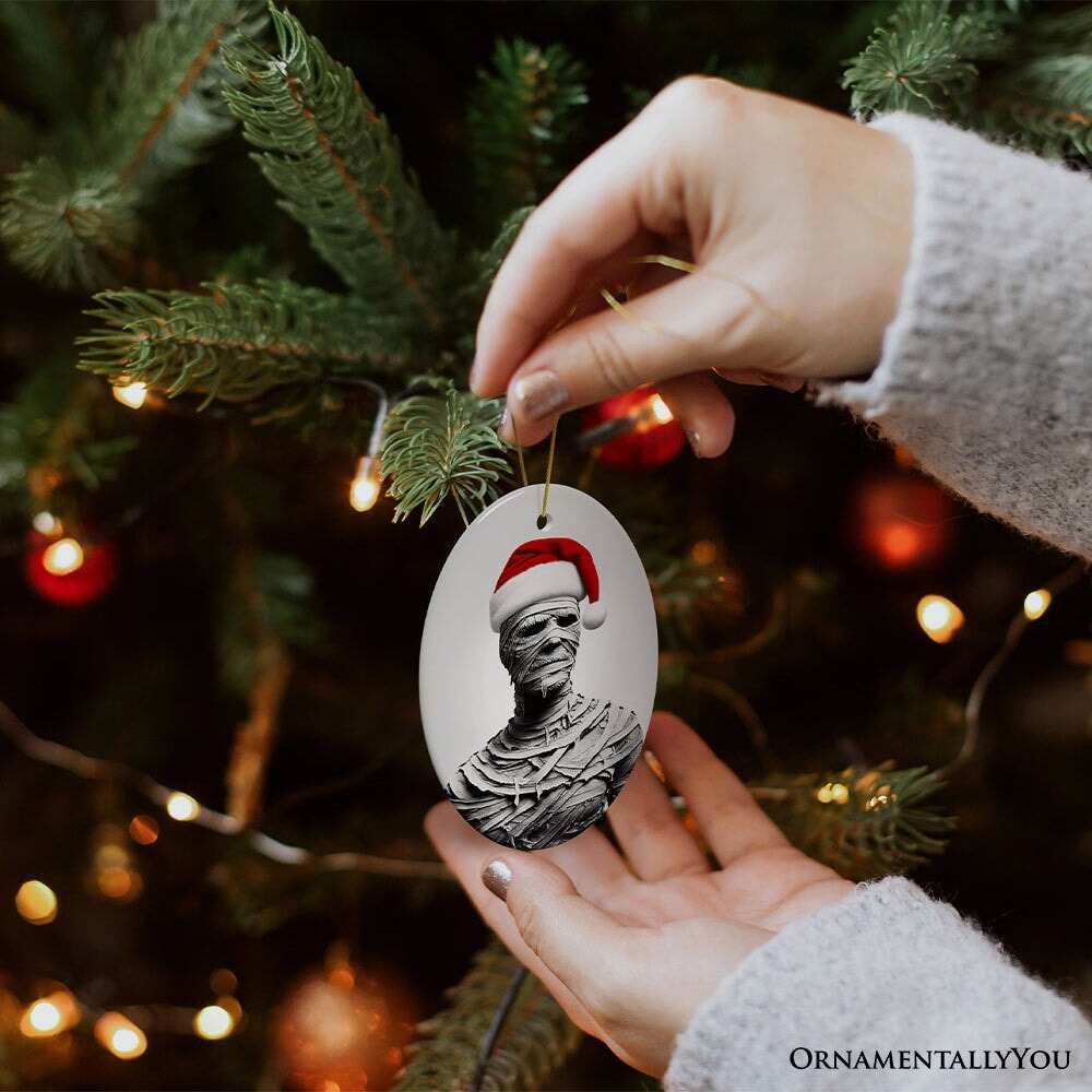 Ghoulish Mummy with Santa Hat Ornament, Sinister Holiday Keepsake for Halloween Lovers - Oval